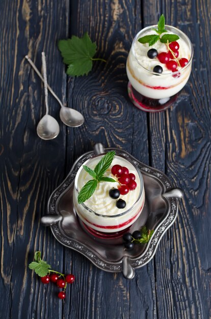 Sweet dessert with berry and cottage cheese in a glass