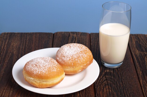 Sweet donuts and glass of milk for breakfast