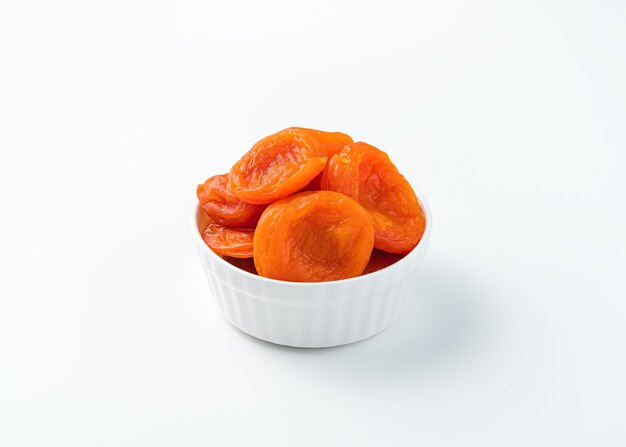 Sweet dried apricots on a white background. Healthy snacks. Side view.