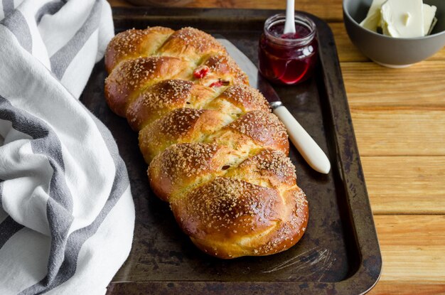 sweet Easter bread with raisins on an old baking tray jam and butter Cozonac Bulgarian Easter bread