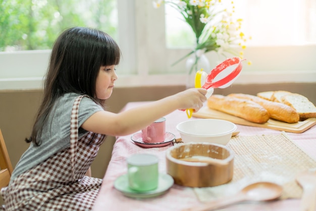 お父さんのお母さんと娘の幸せの瞬間と楽しい趣味の家庭の台所の背景と一緒に料理する甘い家族の週末の活動