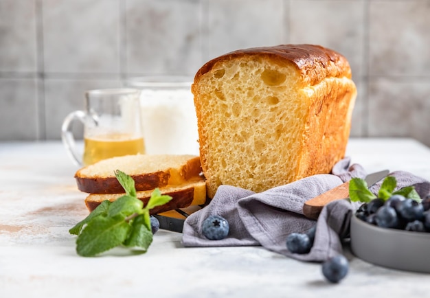 Sweet french brioche served with honey and blueberry for healthy breakfast Homemade bread