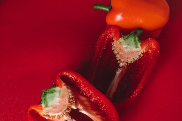 SWEET fresh RED PEPPER ON A RED BACKGROUND cut in half thick smoke around photo for the menu proper nutrition fresh vegetables