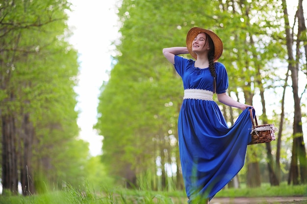 A sweet girl in the countryside on a walk in the sunny evening