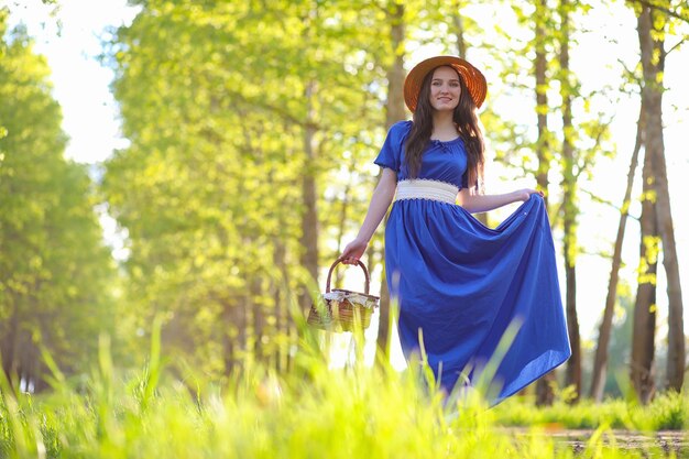 A sweet girl in the countryside on a walk in the sunny evening