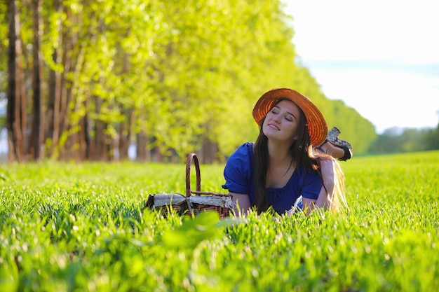 A sweet girl in the countryside on a walk in the sunny evening