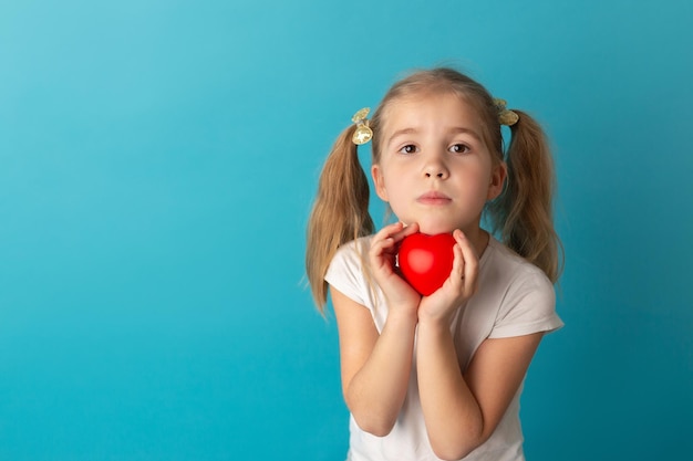 Sweet girl holding red heart Valentines day or healthcare medical concept Peace on the world No war