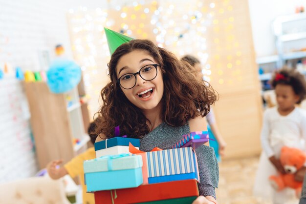 Sweet girl rejoices at huge number of gifts at birthday.