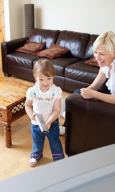 Sweet girl standing in front of  the television 