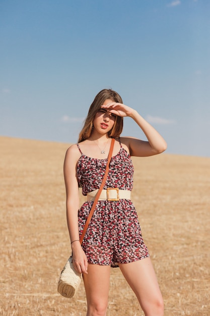 Sweet girl in wheat field in summer