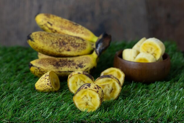 Sweet golden banana fruit isolate on Green grass