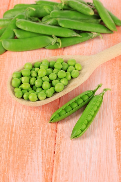 Sweet green peas on wooden background