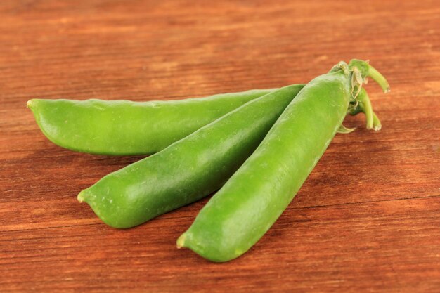 Sweet green peas on wooden background