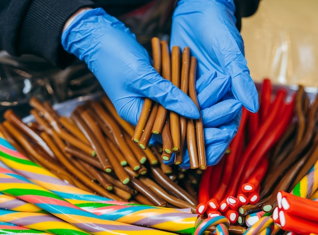 Sweet gummy multicolored sticks on a funfair stand