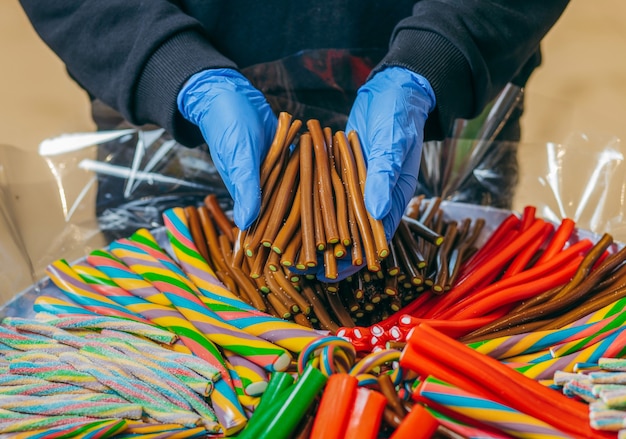 Sweet gummy multicolored sticks on a funfair stand