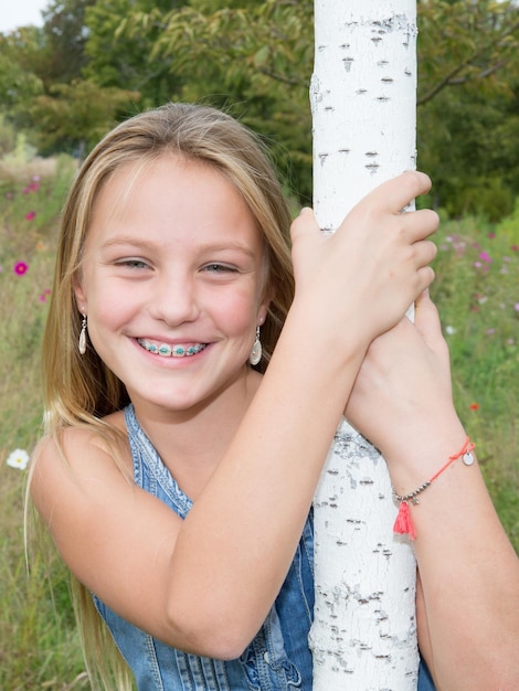 Sweet happy and smiling young girl in a park