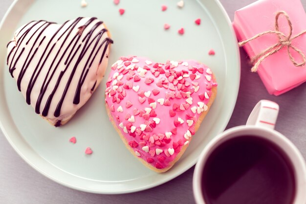 Sweet heart shaped donuts with coffee