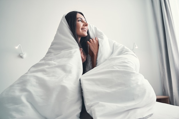 Sweet home. Attractive young woman feeling happiness while spending her weekend at home