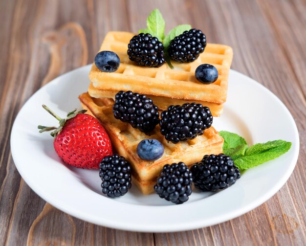 Sweet Homemade Berry Belgian Waffle on white plate