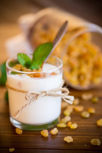 Sweet homemade yogurt with raisins in a glass