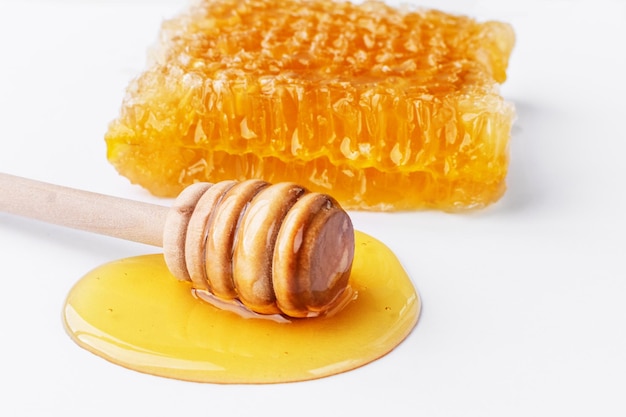 Sweet honey and honeycomb Healthy organic honey slices of honeycomb and wooden honey dipper