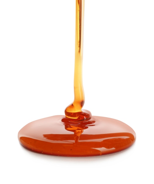 Photo sweet honey pouring on white background