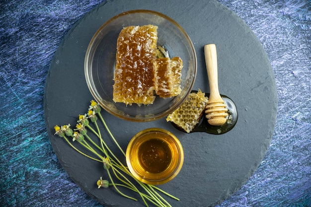 Sweet Honeycomb in wooden plate on wooden background Natural honey with honeycomb