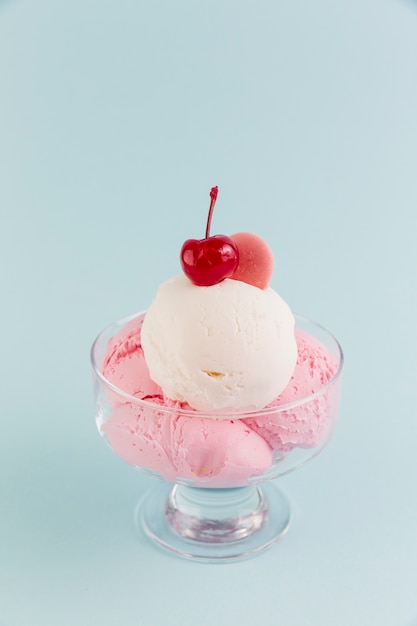 Sweet ice cream in bowl on light background