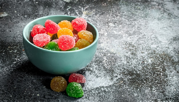 Sweet jelly in a bowl. On a rustic background.