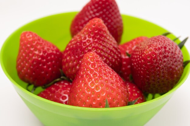 Sweet juicy tasty strawberries in a green bowl