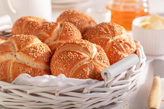 Sweet Kaiser rolls with sesame seeds served with drink