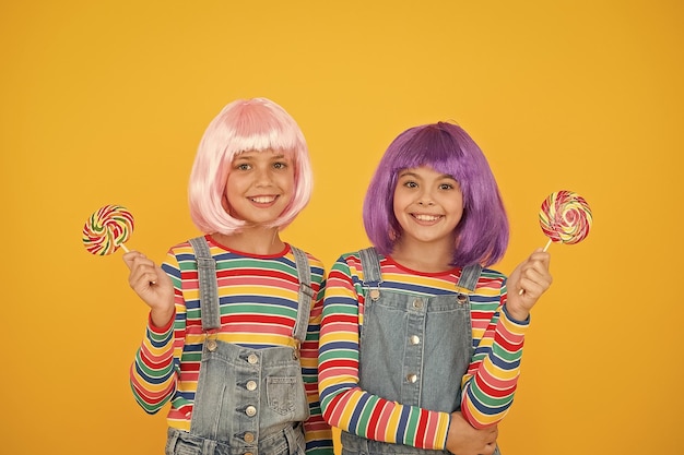 Sweet life Anime cosplay party concept Happy little girls Anime fan Kids with artificial hairstyles eating lollipops Anime convention Vibrant characters fantastical themes Modern childhood