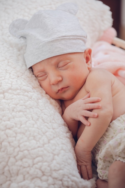 Sweet little baby sleeping on a little lamb blanket