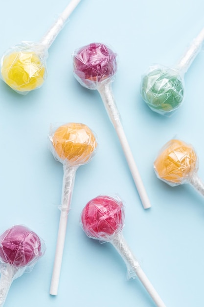 Sweet lollipops on blue background