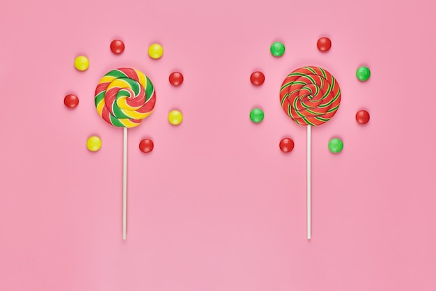 Sweet lollipops and candy isolated on pink