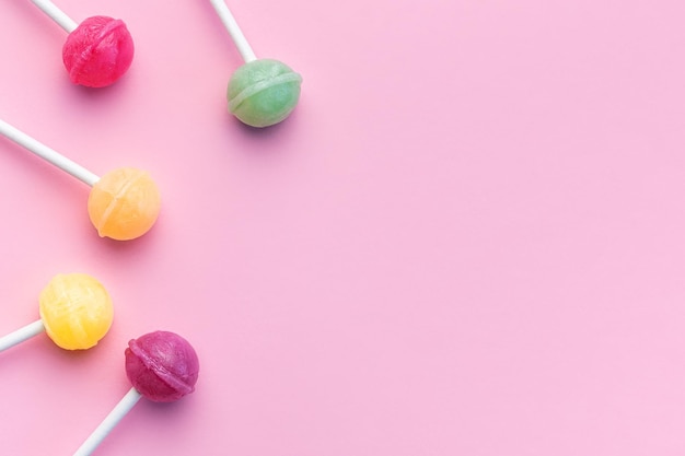 Sweet lollipops on pink background