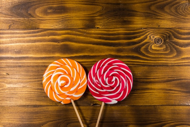 Sweet lollipops on rustic  wooden background Top view