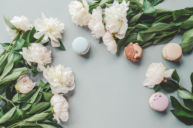 Sweet macarons and white peonies beautiful photo