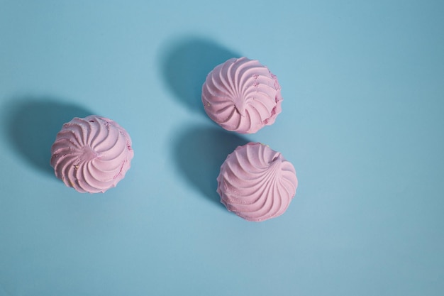 Sweet marshmallow lies on a blue background minimalism dessert