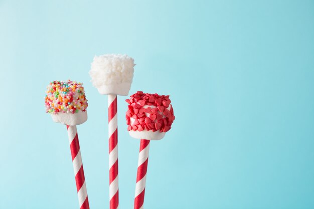 Sweet marshmallow and lollipops on blue,