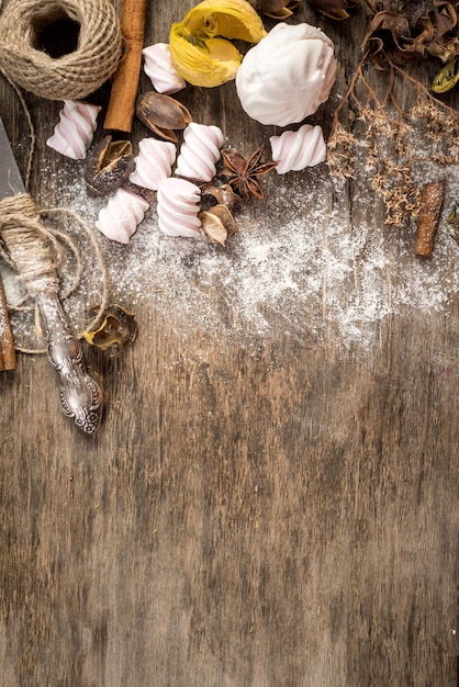 Sweet marshmallow pieces with different ingredients on wooden background. Top view. Copy space