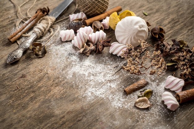 Sweet marshmallow pieces with different ingredients on wooden background. Top view. Copy space