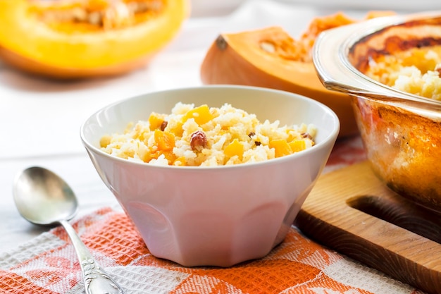 Sweet milky millet and rice porridge with pumpkin and raisins