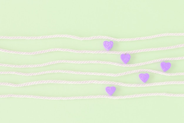 Sweet mini hearts in colorful on white rope  in pastel  background