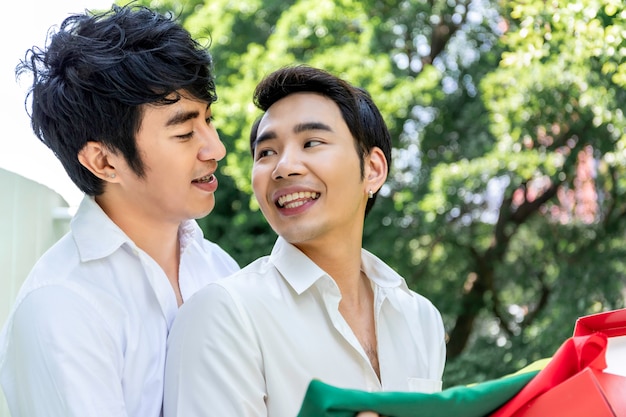 Sweet moment of love. Portrait of Asian homosexual couple hug and surprise box gift to boyfriend. Concept LGBT gay. 