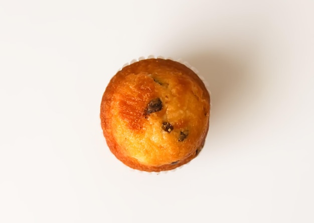 Sweet muffin cup cake closeup on white background