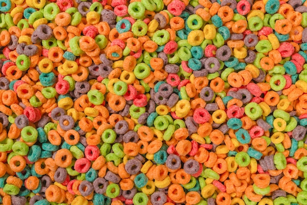 Sweet multicolored flakes cereal loops as a background