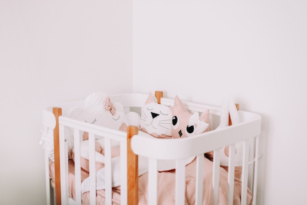 sweet nursery room decorations stylish baby room interior with comfortable crib and funny pink decorative pillows