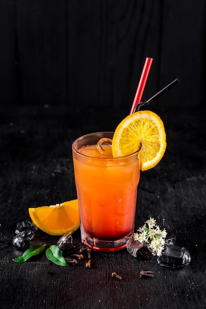 Sweet orange cocktail on black background