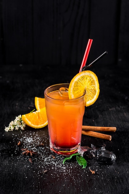 Sweet orange cocktail on black background